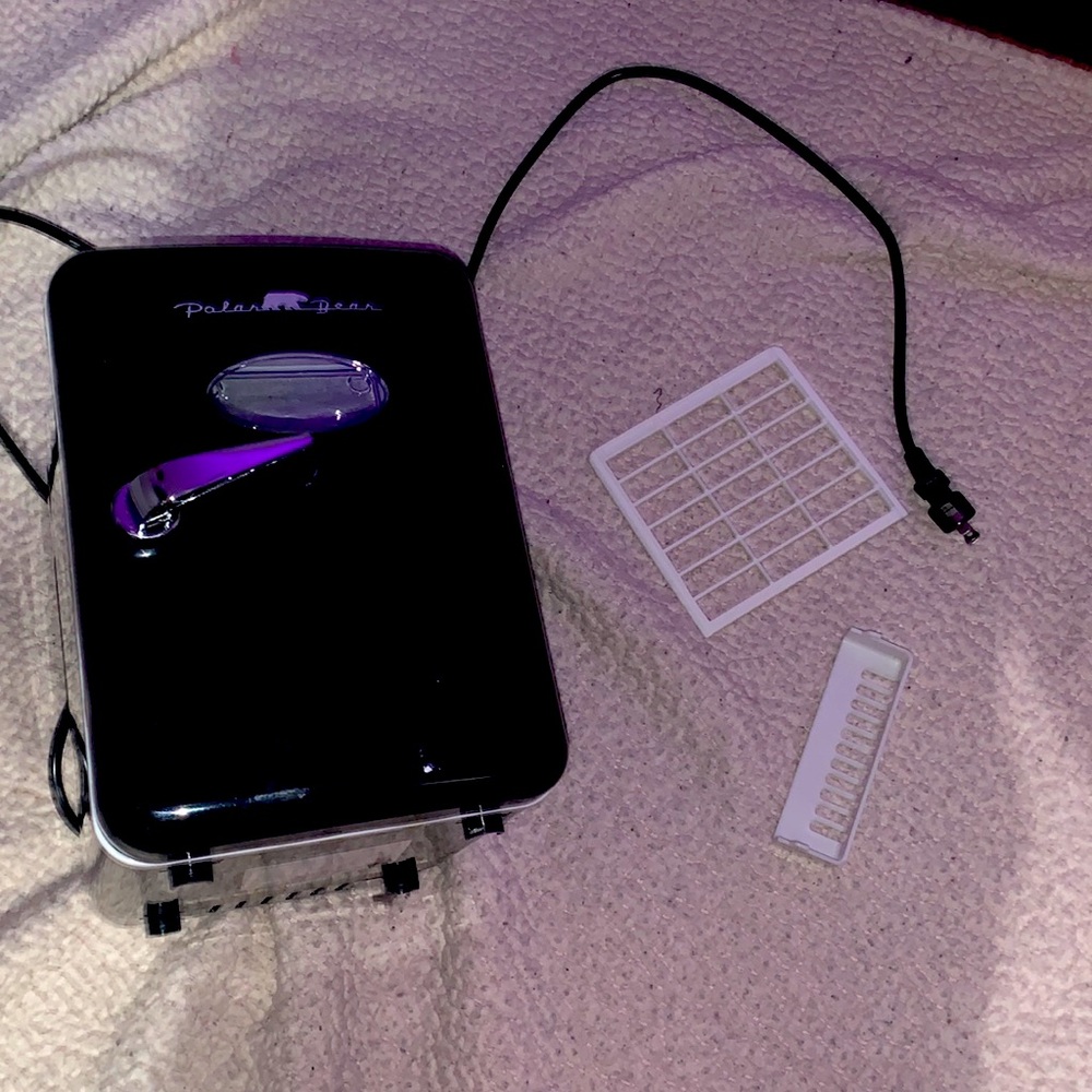 Polar bear mini fridge it’s black and comes with two plastic slide in piece